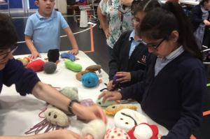 A demonstrator shows off our cuddly microbe plushies