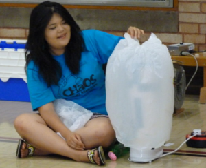 A demonstrator looks at the bag as it inflates over a toaster
